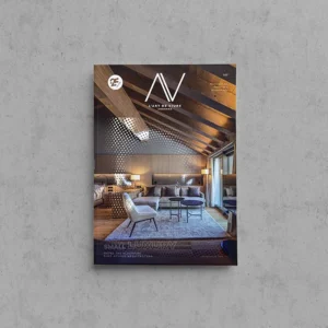 Portada de L'Art de Viure Andorra núm. 147 amb la sala d'estar d'una suite de l'Hotel The Blackpine, sota una coberta de fusta a dues aigües amb un element metàl·lic perforat, sota el títol Small luxury.